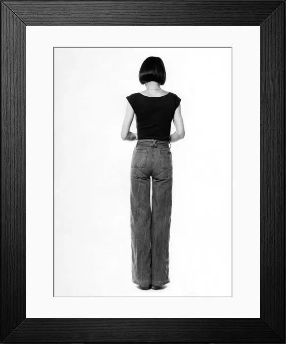 Framed Print : Fashion - 1970s. Back of woman. Jeans and t-shirt. October 1975 P017333 Framed Print : Fashion - 1970s. Back of woman. Jeans and t-shirt. October 1975 P017333