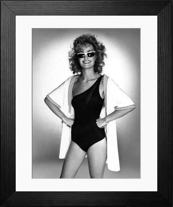 Framed Print : Woman wearing a one-shouldered swimsuit with a short towelling robe over the top Framed Print : Woman wearing a one-shouldered swimsuit with a short towelling robe over the top