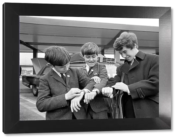 Three children check their watches against local US time on arrival in New York
