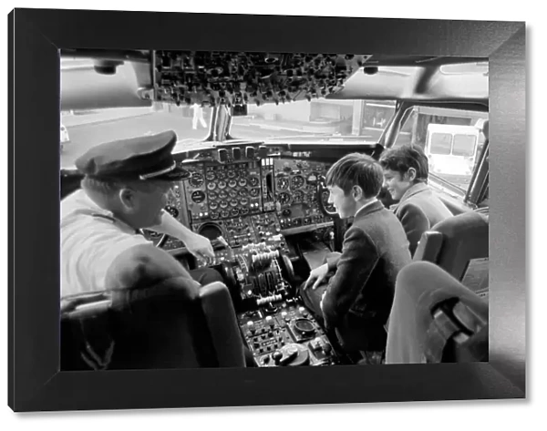 Children Transport Aviation. Children looking at the controls of a TWA 707 plane in