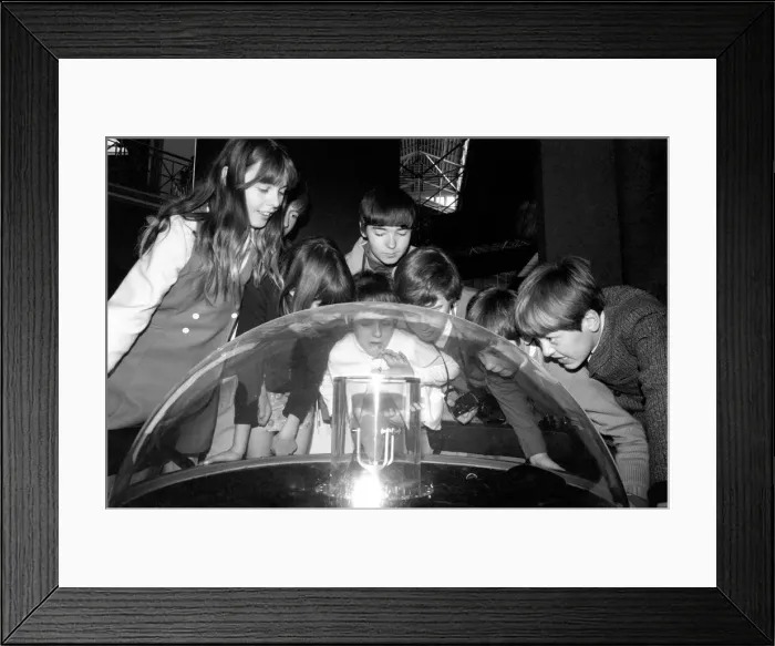 Framed Print : Holiday makers looking at the moon rock from Apollo IIs moon landing Framed Print : Holiday makers looking at the moon rock from Apollo IIs moon landing
