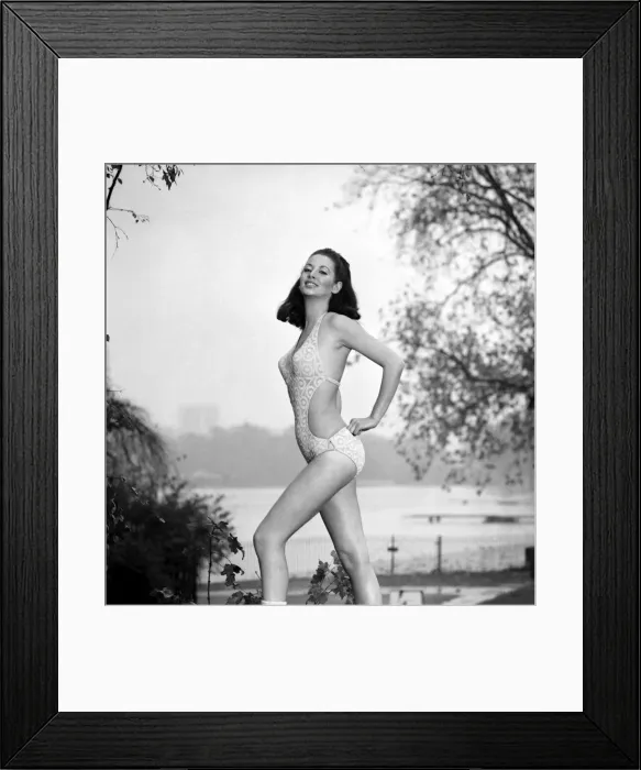 Framed Print : Model Marion Proffitt wearing a Turquoise Lycra one-piece swimsuit cut low at the sides