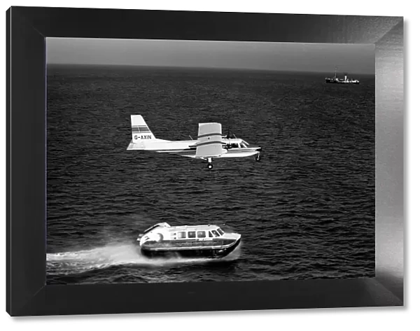 Islander aircraft flies over Cushion Craft Hovercraft, off the Isle of Wight