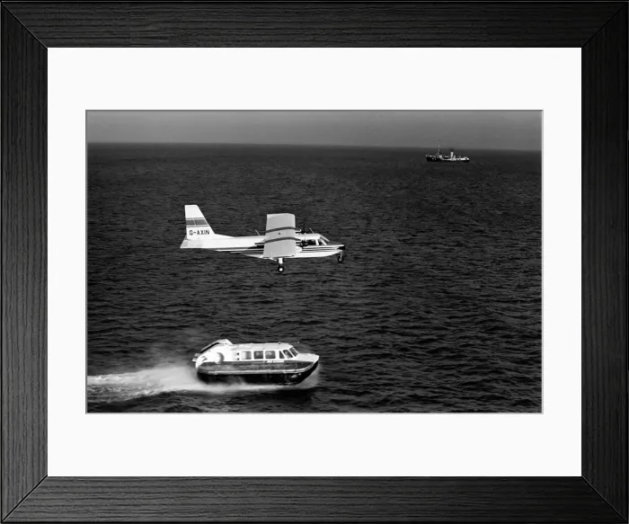Framed Print : Islander aircraft flies over Cushion Craft Hovercraft, off the Isle of Wight Framed Print : Islander aircraft flies over Cushion Craft Hovercraft, off the Isle of Wight