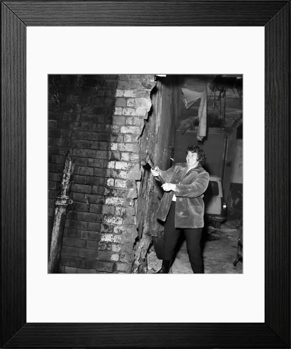 Framed Print : Woman Humour: Woman raising floor boards with a pick axe
