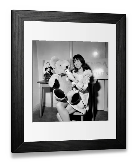 Framed Print : Teenage girl putting the finishing touches to a teddy bear Framed Print : Teenage girl putting the finishing touches to a teddy bear