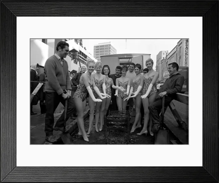 Framed Print : Danger - Men At Work ! Warming up - TV toppers dancers warm themselves round Framed Print : Danger - Men At Work ! Warming up - TV toppers dancers warm themselves round