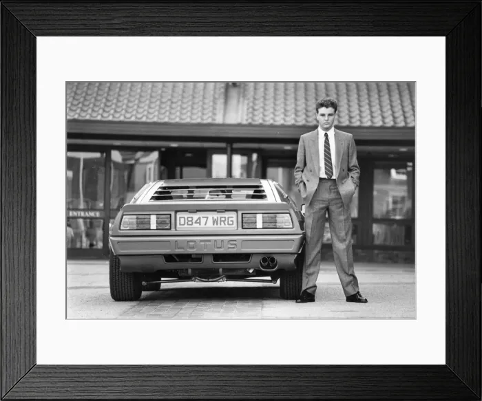 Framed Print : A young man posing in the latest suit with a must have accessory - a Lotus car Framed Print : A young man posing in the latest suit with a must have accessory - a Lotus car