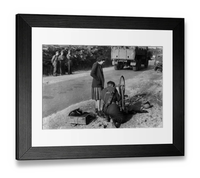 Framed Print : World War II: Normandy Invasion. A British soldier helps a French girl to mend a puncture Framed Print : World War II: Normandy Invasion. A British soldier helps a French girl to mend a puncture