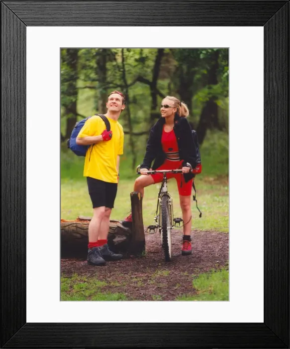 Framed Print : A young couple enjoy a romantic day out in the countryside hiking and cycling