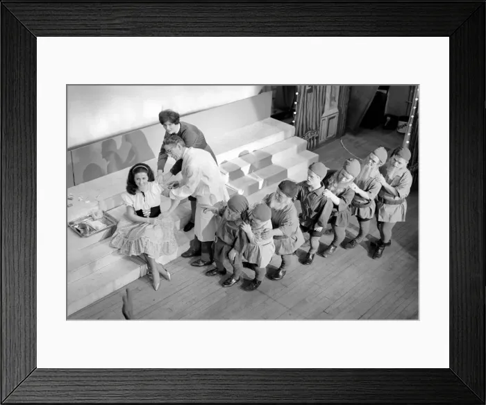 Framed Print : A doctor with his syringe makes ready to give anti-flu vaccine to Margaret Ayre Framed Print : A doctor with his syringe makes ready to give anti-flu vaccine to Margaret Ayre