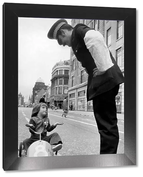 Its a fair cop for little Craig Wright as he pedals along Argyle Street