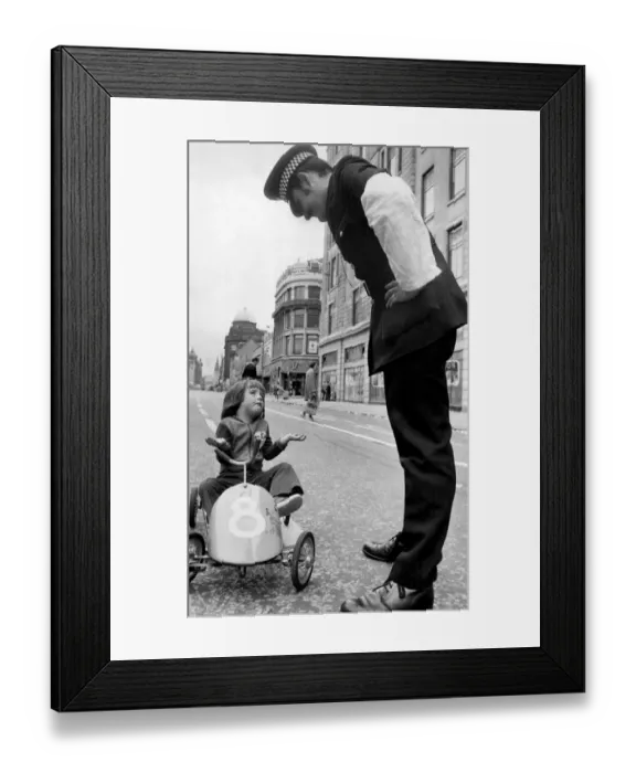 Framed Print : Its a fair cop for little Craig Wright as he pedals along Argyle Street