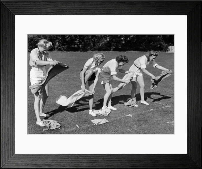 Framed Print : Sports Day Firewomen having fun in the dressing up race seen here hastily changing Framed Print : Sports Day Firewomen having fun in the dressing up race seen here hastily changing