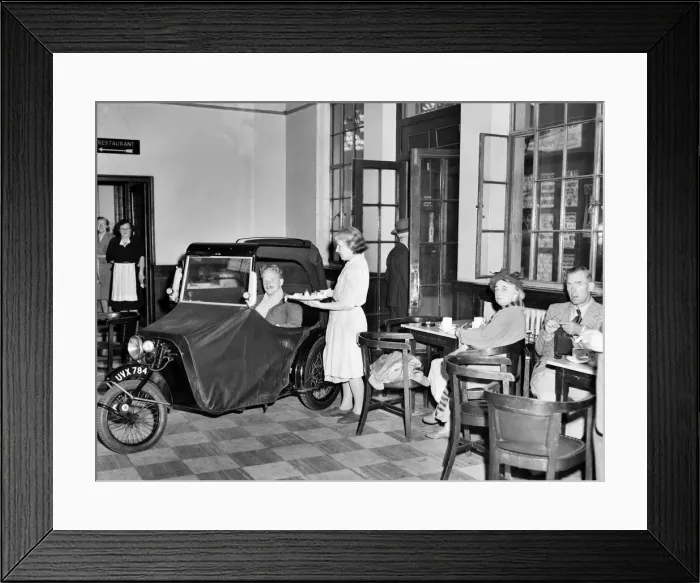 Framed Print : A invalid car owner drives through the open door of the Brighton railway street Framed Print : A invalid car owner drives through the open door of the Brighton railway street