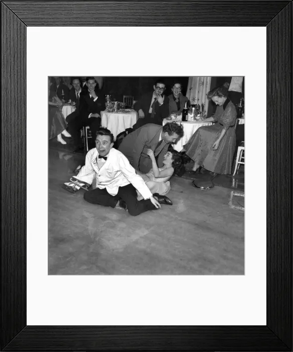 Framed Print : Frankie Howard tries skating with Jane Conlon, of Earls Court Framed Print : Frankie Howard tries skating with Jane Conlon, of Earls Court