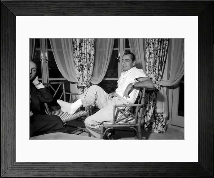 Framed Print : Donald Zec with film star Alan Ladd, who has injured his foot. October 1953 D6473 Framed Print : Donald Zec with film star Alan Ladd, who has injured his foot. October 1953 D6473