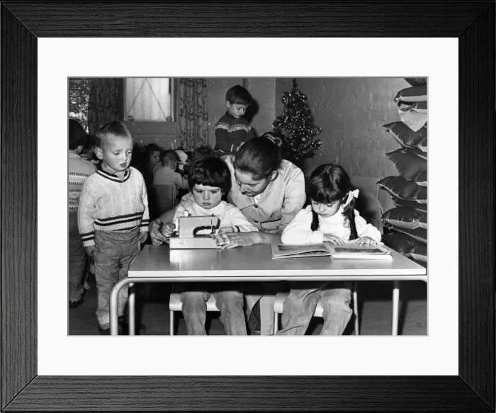 Framed Print : 3 years old Susan Willis gets some practice in on a sewing maching assisted by nursery Framed Print : 3 years old Susan Willis gets some practice in on a sewing maching assisted by nursery