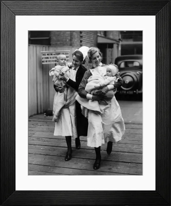 Framed Print : Nurses help evacuate two babies from Great Ormond Street Hospital Circa 1940