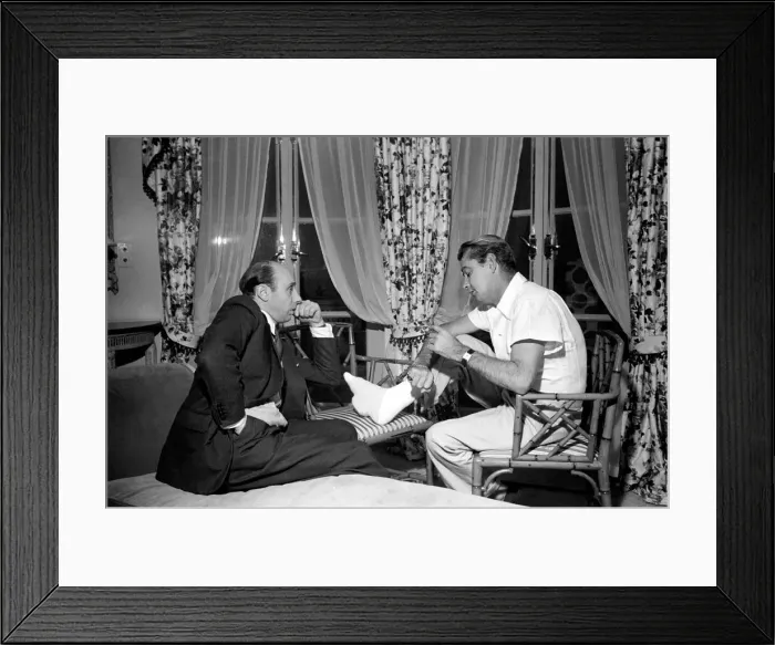 Framed Print : Donald Zec with film star Alan Ladd, who has injured his foot. October 1953 D6473-003 Framed Print : Donald Zec with film star Alan Ladd, who has injured his foot. October 1953 D6473-003