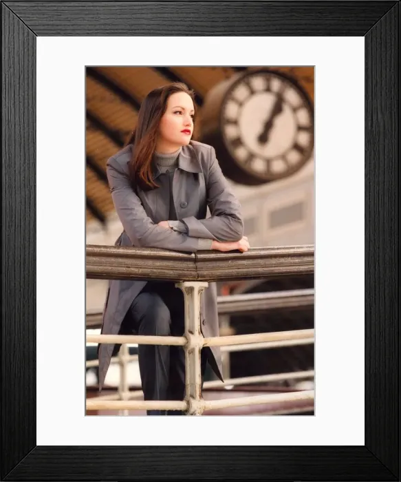 Framed Print : A woman waits for a partner at the Railway station with time ticking by in the background Framed Print : A woman waits for a partner at the Railway station with time ticking by in the background