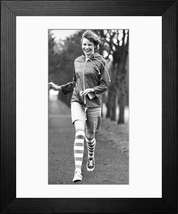 Framed Print : A young enjoys a spot of exercise in the park Framed Print : A young enjoys a spot of exercise in the park
