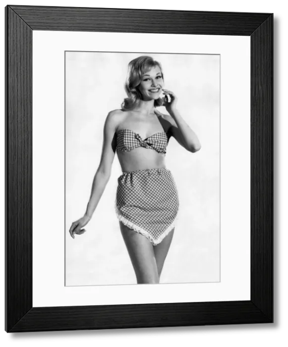 Framed Print : Woman wearing a check patterned bikini with unusual pants June 1962 P011070 Framed Print : Woman wearing a check patterned bikini with unusual pants June 1962 P011070