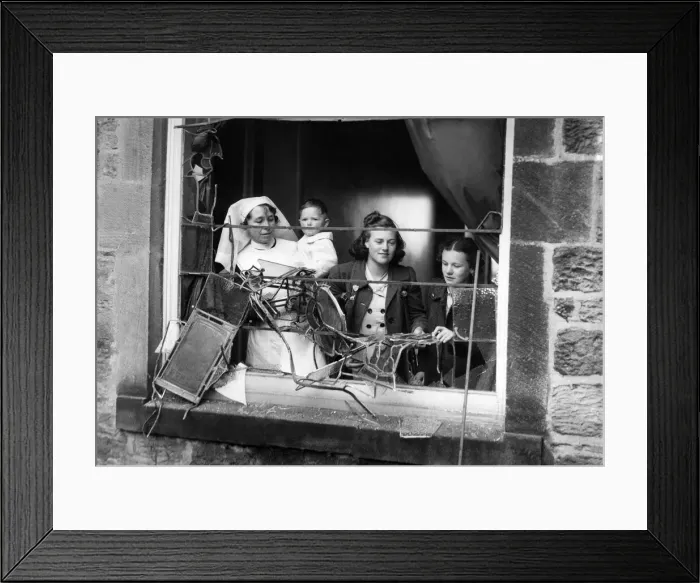 Framed Print : Girls and a nurse holding a litte baby looking out through the smashed window of a bomb Framed Print : Girls and a nurse holding a litte baby looking out through the smashed window of a bomb