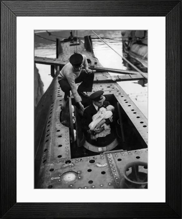 Framed Print : Lieutenant Commander HRB Newton entering in the submarine torpedo space with his son Max