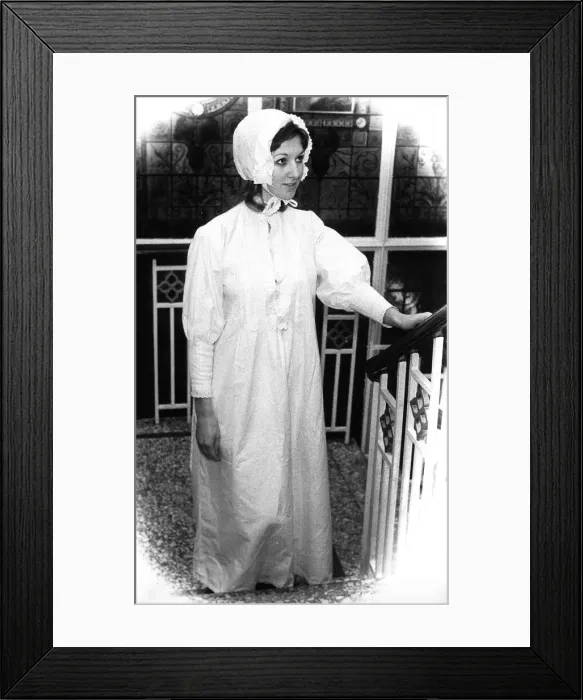 Framed Print : A model posing in the lastest bed wear including bonnet Framed Print : A model posing in the lastest bed wear including bonnet