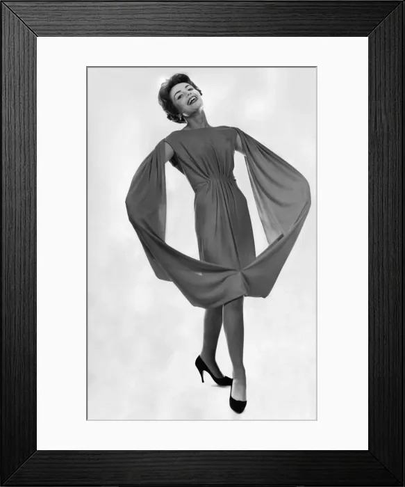 Framed Print : Woman wearing a dress with flared arm sleeves meeting together Framed Print : Woman wearing a dress with flared arm sleeves meeting together