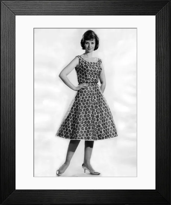Framed Print : Woman wearing a patterned flared dress. May 1962 P011064 Framed Print : Woman wearing a patterned flared dress. May 1962 P011064