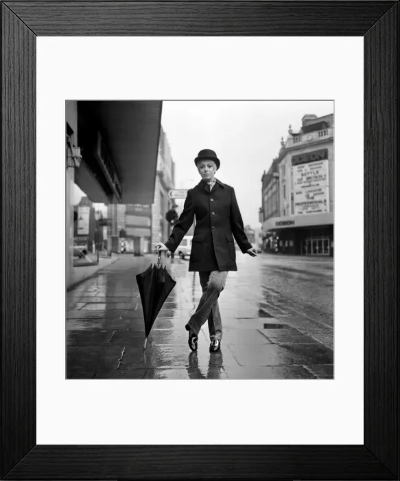 Framed Print : Fashion: Clothing. Unisex clothes. A girl wears a bowler hat, dark overcoat, pin stripes Framed Print : Fashion: Clothing. Unisex clothes. A girl wears a bowler hat, dark overcoat, pin stripes