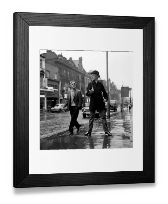 Framed Print : Fashion: Clothing. Unisex clothes. A girl wears a bowler hat, dark overcoat, pin stripes Framed Print : Fashion: Clothing. Unisex clothes. A girl wears a bowler hat, dark overcoat, pin stripes