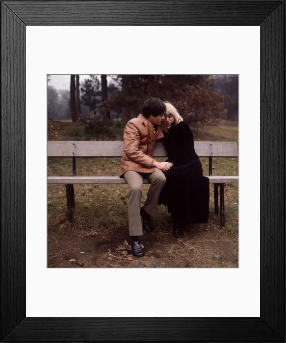 Framed Print : Young couple sitting on a bench Framed Print : Young couple sitting on a bench