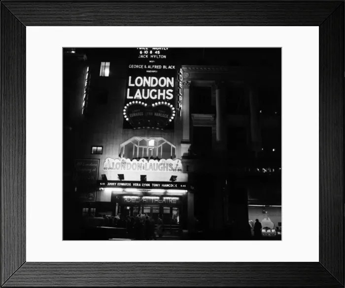Framed Print : Names of stage shows in lights at London Theatres (night shots). London Laughs