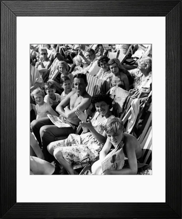 Framed Print : Holidays: Holiday makers Sunbathing whilst watching the Minor Beach Fashion Show Framed Print : Holidays: Holiday makers Sunbathing whilst watching the Minor Beach Fashion Show