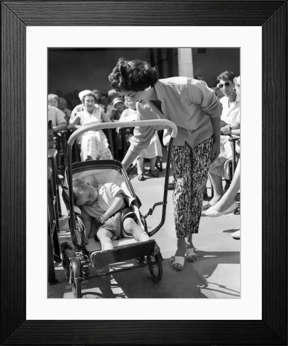 Framed Print : Women: Beauty contest. What all the fuss about as Kenneth Burnett a baby of two sleeps