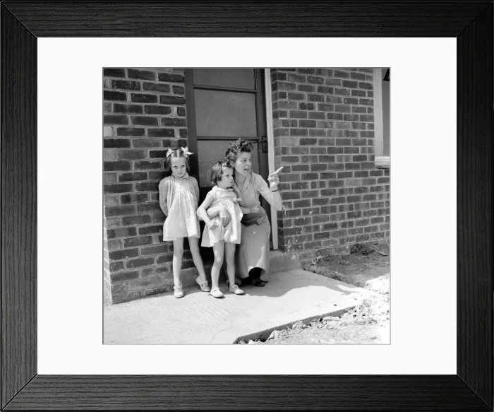 Framed Print : Mrs. Kirby and her daughters, Carol, 5, and Sandra, 4, outside their council house today Framed Print : Mrs. Kirby and her daughters, Carol, 5, and Sandra, 4, outside their council house today