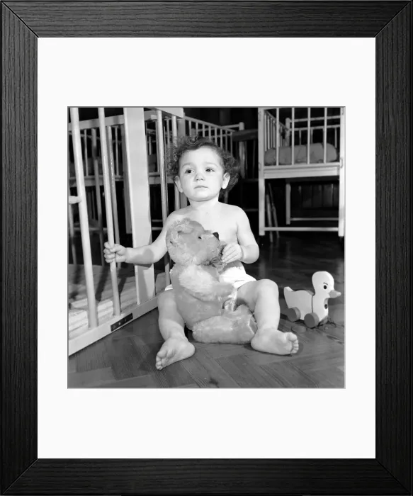 Framed Print : Child with teddy bear and toy top hat. December 1953 D7586-001