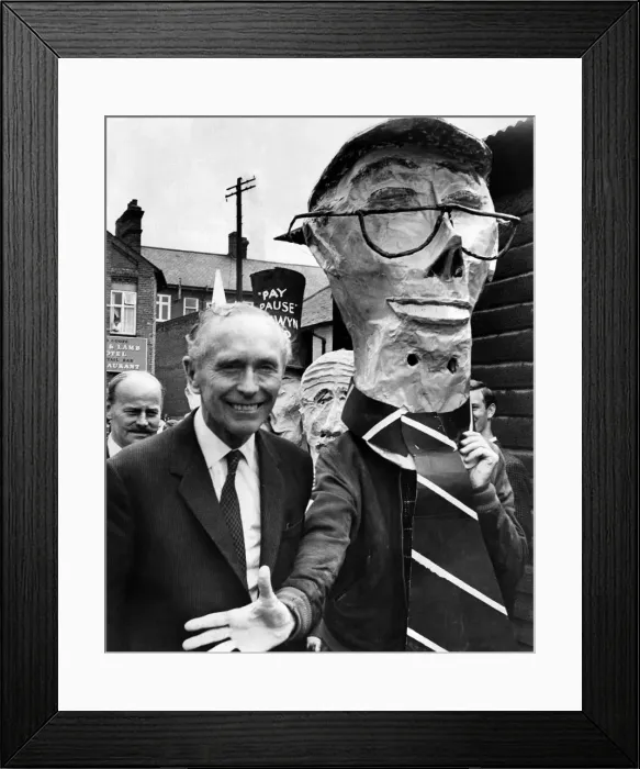 Framed Print : The Prime Minister, Alec Douglas-Home rejects the hand of somebody wearing a mask of Framed Print : The Prime Minister, Alec Douglas-Home rejects the hand of somebody wearing a mask of