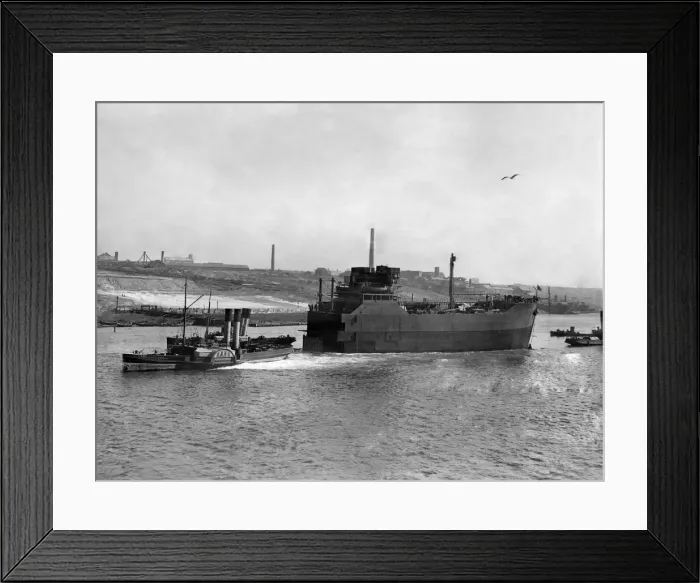 Framed Print : World War II Shipbuilding. Tugs pull The bow Section of a new cargo ship along the river Framed Print : World War II Shipbuilding. Tugs pull The bow Section of a new cargo ship along the river