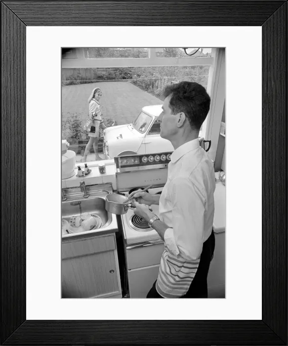 Framed Print : A man a woman living in a sububan area of Manchester at home