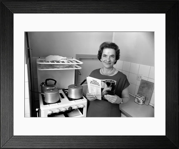 Framed Print : Household - Domestic Chores Cooking. A woman using her gas over in the kitchen of her Framed Print : Household - Domestic Chores Cooking. A woman using her gas over in the kitchen of her