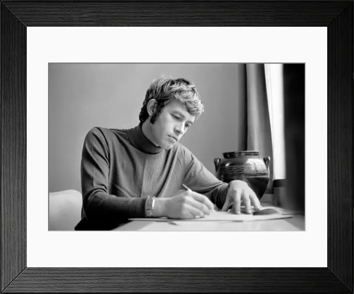 Framed Print : Families: Mother, father and children. Man relaxing at home, reading a book on his sofa Framed Print : Families: Mother, father and children. Man relaxing at home, reading a book on his sofa