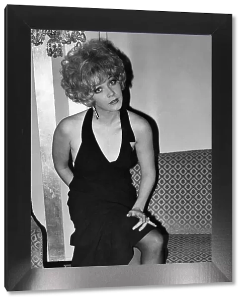 Film actress Linda Thorson wearing a glamourous black dress