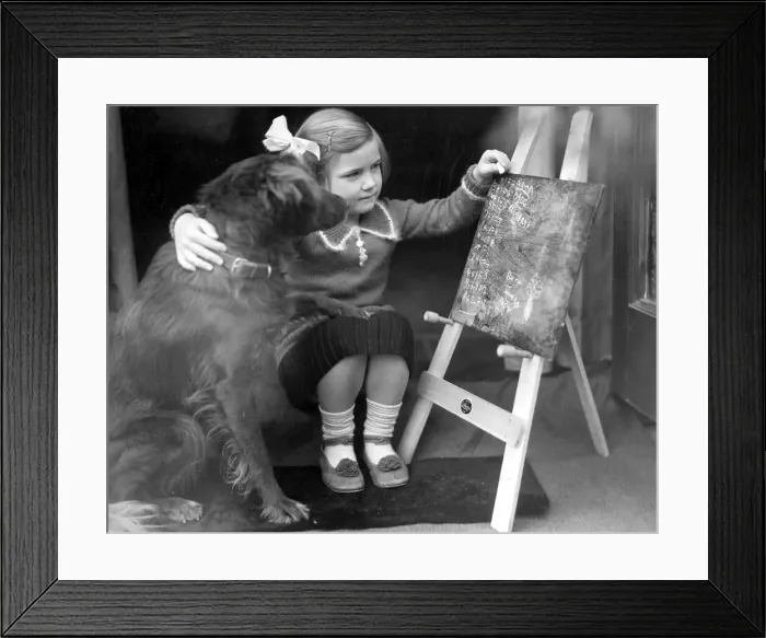 Framed Print : Young girl sitting with dog in front of a blackboard c. 1945 P044483 Framed Print : Young girl sitting with dog in front of a blackboard c. 1945 P044483