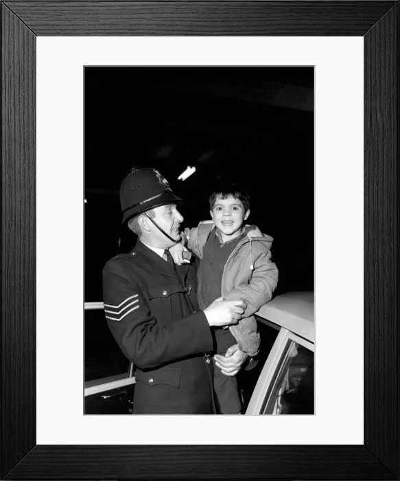 Framed Print : Children with policemen: A six year old boy who calls himself George Mason is Framed Print : Children with policemen: A six year old boy who calls himself George Mason is
