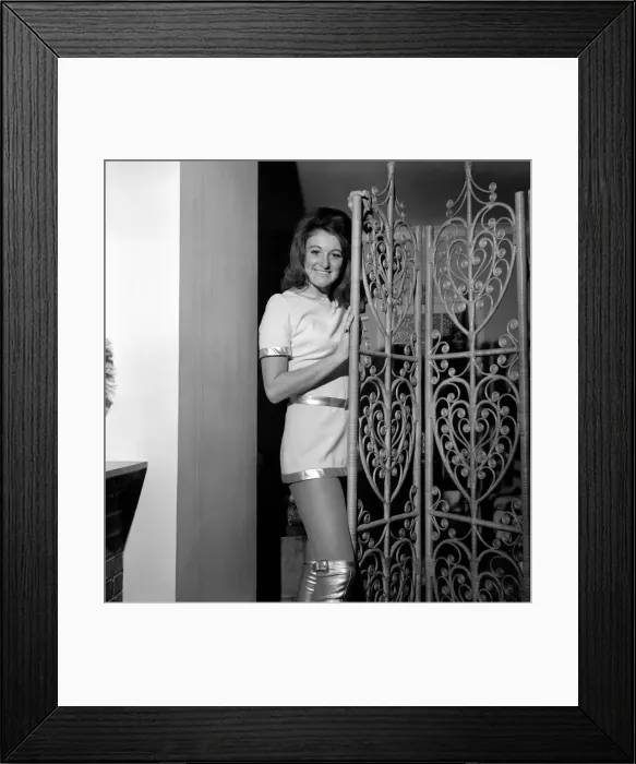 Framed Print : Model Susie King poses wearing a mini dress and knee high boots Framed Print : Model Susie King poses wearing a mini dress and knee high boots