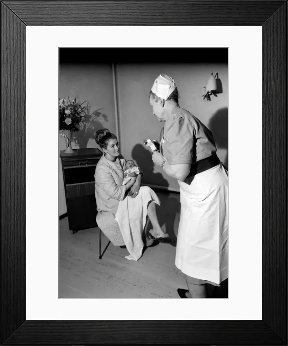 Framed Print : Midwife May Guthrie-Lacy photographs the 287th baby which she has delivered at Lytham